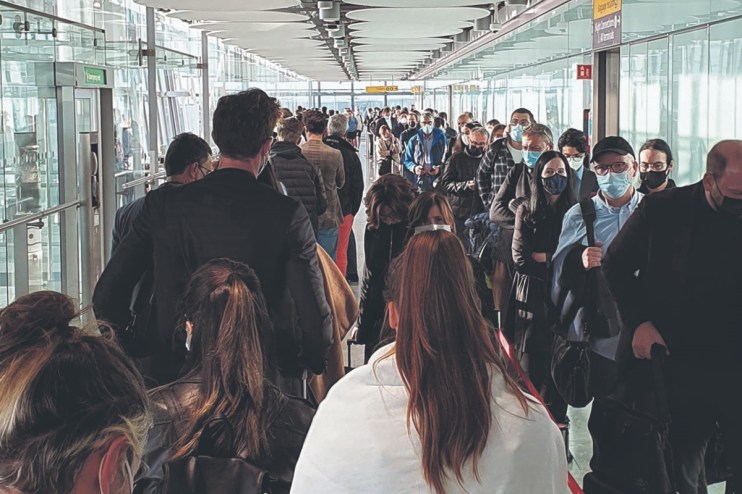 Passengers queue for the Arrival Hall at London Heathrow Airport's Terminal 5