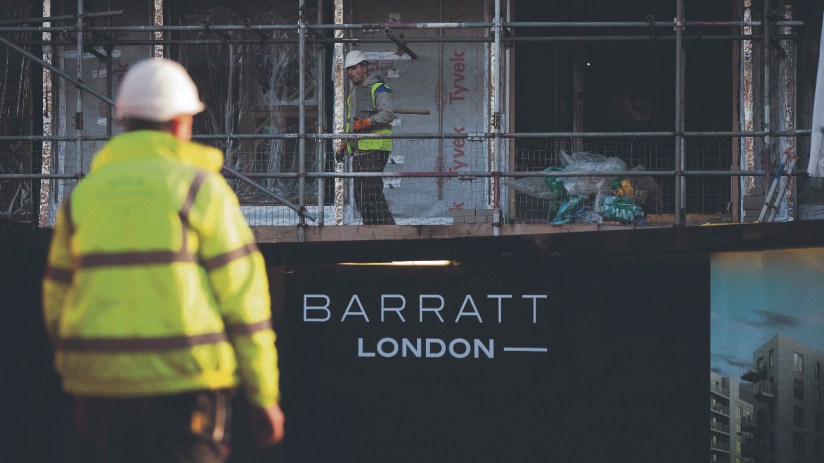 A "Barratt London" logo sits on a sign outside the "Catford Green" residential apartment complex (Photographer: Simon Dawson/Bloomberg via Getty Images)