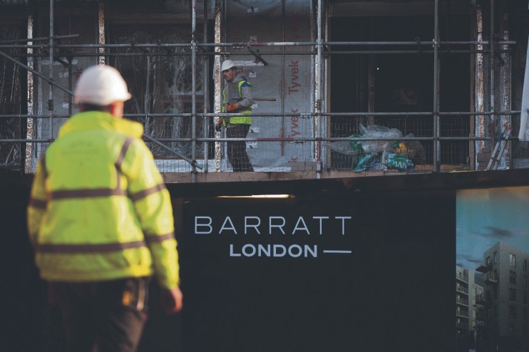 A "Barratt London" logo sits on a sign outside the "Catford Green" residential apartment complex (Photographer: Simon Dawson/Bloomberg via Getty Images)