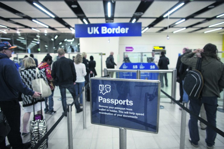 Border Force check the passports of passengers (Photo by Oli Scarff/Getty Images)