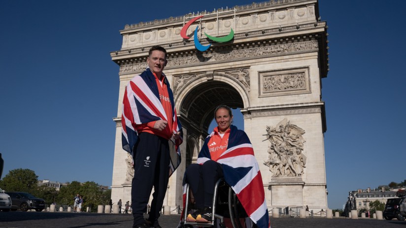 image of Paralympics GB para athletes Terry Bywater and Lucy Shuker outside Paris's Arc de Triomphe