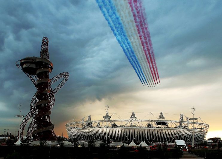 LONDON, ENGLAND - JULY 27: The Red Arrows fly over Olympic Stadium during the Opening Ceremony for the 2012 Summer Olympics Games on July 27, 2012 at Olympic Park in London, England. (Photo by Elsa/Getty Images)