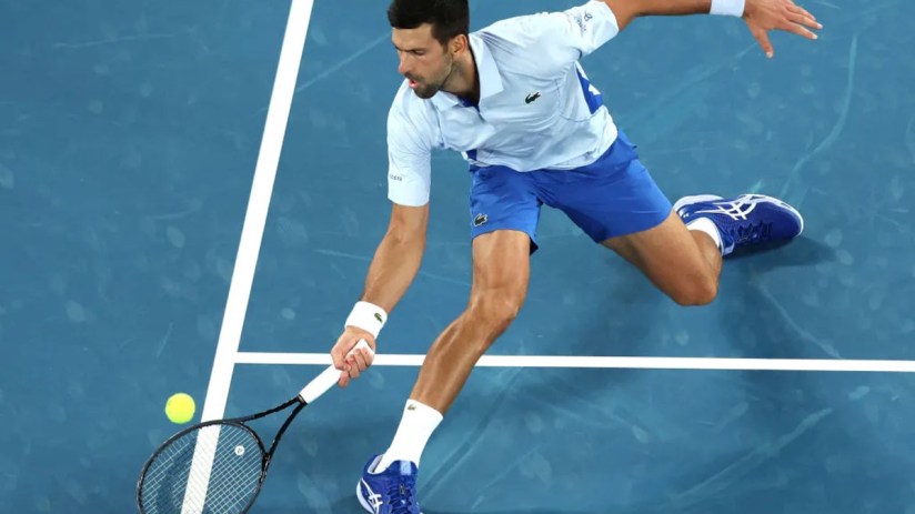 Novak Djokovic lunging forward for a shot