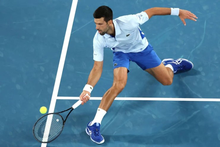 Novak Djokovic lunging forward for a shot