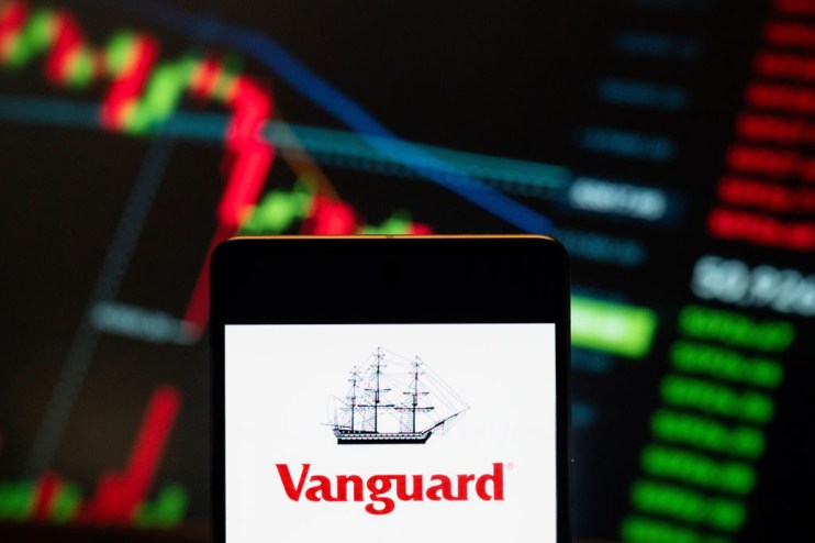 Vanguard logo seen displayed on a smartphone with a graph in the background. (Photo Illustration by Budrul Chukrut/SOPA Images/LightRocket via Getty Images)
