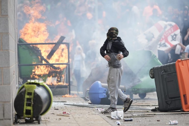 ROTHERHAM, ENGLAND - AUGUST 4: Anti-migration protesters are seen during riots outside of the Holiday Inn Express in Manvers, which is being used as an asylum hotel, on August 4, 2024 in Rotherham, United Kingdom. Yesterday saw widespread violence as Far-right agitators in Liverpool and Manchester rioted and looted shops. Police were attacked and injured and dozens of arrests were made. (Photo by Christopher Furlong/Getty Images)