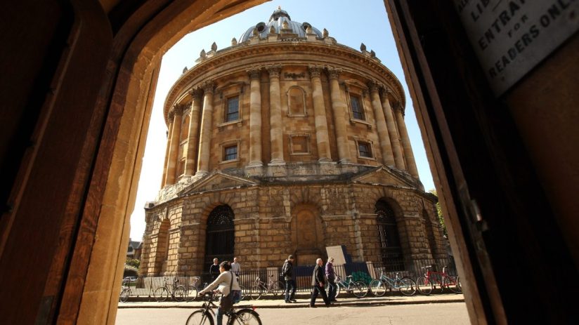 OXFORD, ENGLAND - OCTOBER 08: A cyclist travels past the Radcliffe Camera building in Oxford city centre as Oxford University commences its academic year on October 8, 2009 in Oxford, England. Oxford University has a student population in excess of 20,000 taken from over 140 countries around the world. The University is made up of 38 independent, self-governing colleges, three of which: University College, Balliol College, and Merton College, were established by the 13th century. According to the QS/Times Higher Education rankings, Oxford has slipped down the international league table from fourth to a joint fifth place with Imperial College London. (Photo by Oli Scarff/Getty Images)