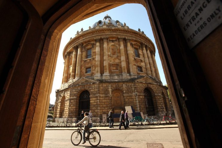 OXFORD, ENGLAND - OCTOBER 08: A cyclist travels past the Radcliffe Camera building in Oxford city centre as Oxford University commences its academic year on October 8, 2009 in Oxford, England. Oxford University has a student population in excess of 20,000 taken from over 140 countries around the world. The University is made up of 38 independent, self-governing colleges, three of which: University College, Balliol College, and Merton College, were established by the 13th century. According to the QS/Times Higher Education rankings, Oxford has slipped down the international league table from fourth to a joint fifth place with Imperial College London. (Photo by Oli Scarff/Getty Images)