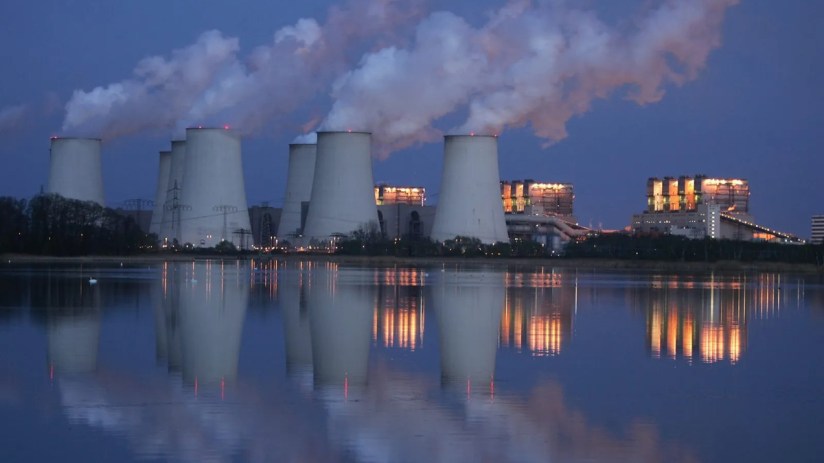 A coal plant pumps out carbon emissions at dusk