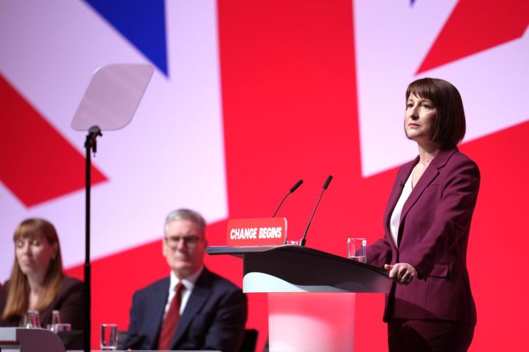 LIVERPOOL, ENGLAND - SEPTEMBER 23: Deputy Prime Minister Angela Rayner, Prime Minister Keir Starmer look on as Chancellor of the Exchequer, Rachel Reeves delivers her keynote speech during the Labour Party Conference 2024 at ACC Liverpool on September 23, 2024 in Liverpool, England. This is Labour's first conference since they were returned as the governing party of The UK and Northern Ireland by voters in the July election, ending 14 years of Conservative rule. They won with a landslide majority of 172 seats, and 412 in total. (Footage by Christopher Furlong/Getty Images)