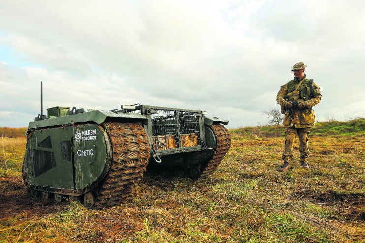 (Owen Stringer, a rifleman in the British Army, operates a Tracked Hybrid Modular Infantry System, THeMIS, developed by Milrem Robotics and QinetiQ Group Plc,. Photographer: Luke MacGregor/Bloomberg via Getty Images)