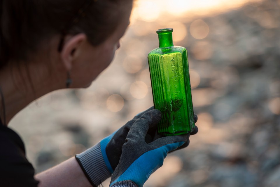 Mudlarking in action, photographed on the Thames between Millenium Bridge and Southwark Bridge