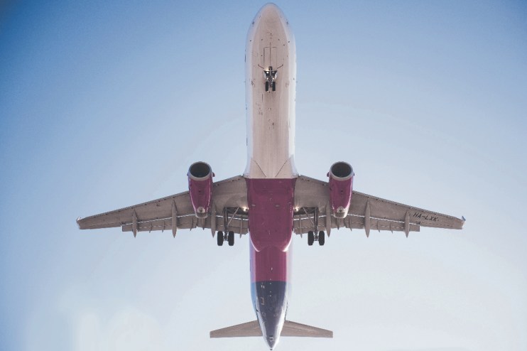Wizz Air slashed its annual profit forecast on Thursday despite losses more than halving amid record passenger traffic.