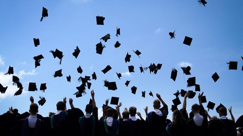 BRADFORD, ENGLAND - JUNE 11: Year 11 students of the BBG Academy celebrate their graduation by throwing their mortaboard hats in the air after the prize giving ceremony in the school hall on June 11, 2021 in Bradford, England. As the pandemic restrictions ease many schools and colleges in the UK are once again performing the graduation ceremonies and last day of school traditions. Last year thousands of pupils missed out on the celebrations due to the coronavirus lockdown and school closures. (Photo by Christopher Furlong/Getty Images)