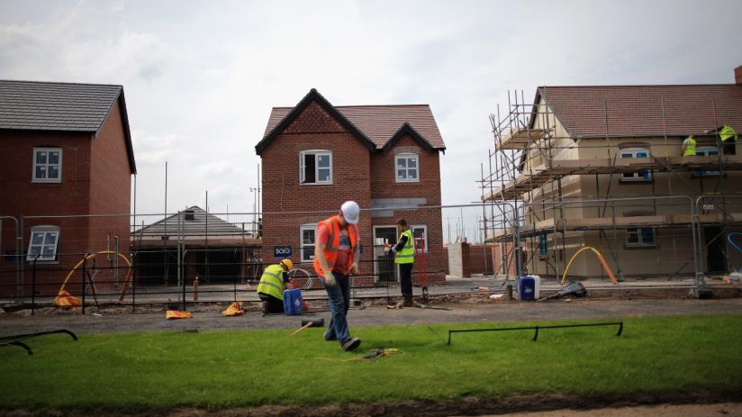 MIDDLEWICH, ENGLAND - MAY 20: Construction workers build new houses on a housing development on May 20, 2014 in Middlewich, England. Official figures have shown that house prices have risen by 8% in the year ending in March. There have been calls by some experts for the UK Help to Buy scheme to be scaled down as it boosts the property market. (Photo by Christopher Furlong/Getty Images)