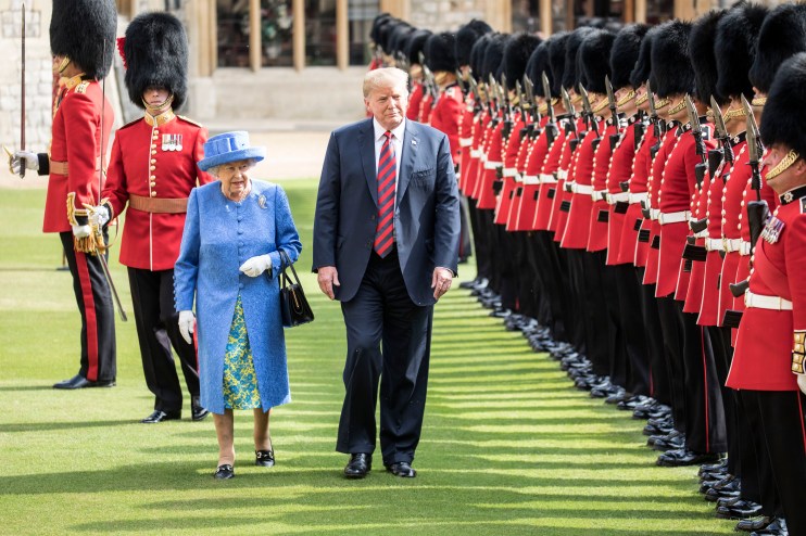 WINDSOR, ENGLAND - JULY 13: U.S. President Donald Trump and Britain's Queen Elizabeth II inspect a Guard of Honour, formed of the Coldstream Guards at Windsor Castle on July 13, 2018 in Windsor, England. Her Majesty welcomed the President and Mrs Trump at the dais in the Quadrangle of the Castle. A Guard of Honour, formed of the Coldstream Guards, gave a Royal Salute and the US National Anthem was played. The Queen and the President inspected the Guard of Honour before watching the military march past. The President and First Lady then joined Her Majesty for tea at the Castle. (Photo by Richard Pohle - WPA Pool/Getty Images)