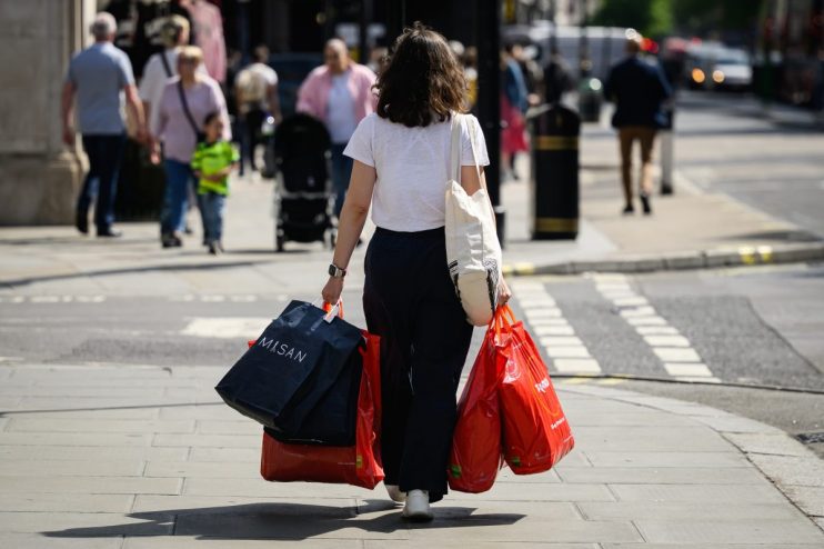 LONDON, ENGLAND - MAY 10: A shopper carries bags through the Oxford Street financial district on May 10, 2024 in London, England. The Office for National Statistics (ONS) revealed that the UK's gross domestic product (GDP) expanded by 0.6% in the three months to March, ending the shallow recession it entered in the second half of last year. (Photo by Leon Neal/Getty Images)