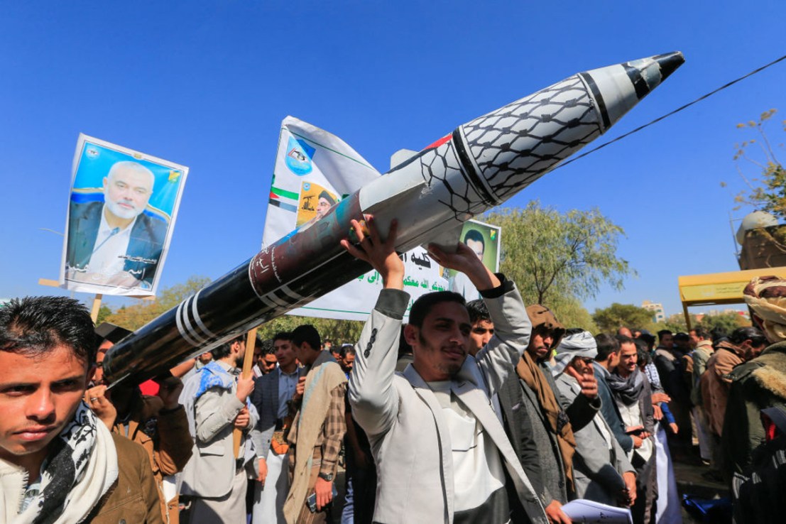 Men carry a mock missile during a rally by university students and faculty denouncing strikes on Yemen and in solidarity with Palestinians, in the Huthi-controlled capital Sanaa on December 25, 2024. Yemen's Huthi rebels said on December 25 that they had fired a ballistic missile at central Israel, with Israeli forces saying they intercepted the attack. (Photo by Mohammed HUWAIS / AFP) (Photo by MOHAMMED HUWAIS/AFP via Getty Images)