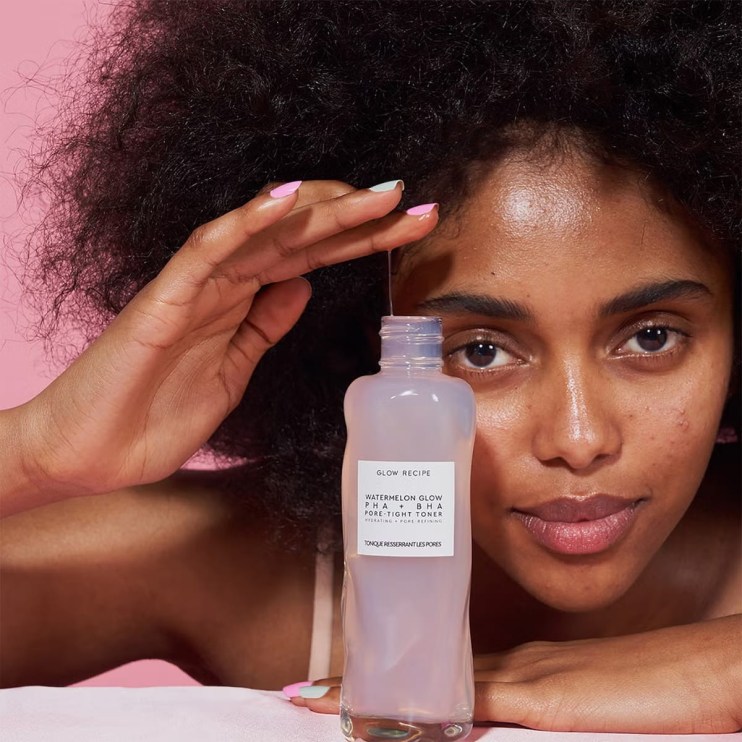 Cleansers from Cult Beauty - Model holding a Cleanser for your skin