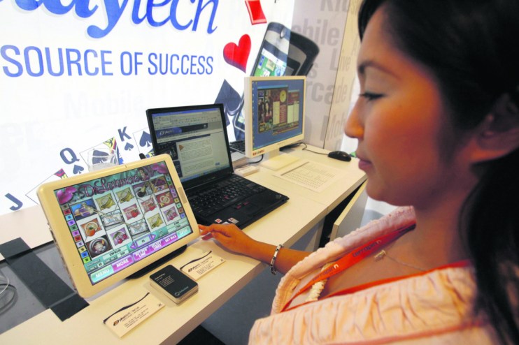 Playtech employee shows the program displayed on the screen for gaming software (ROSLAN RAHMAN/AFP/Getty Images)