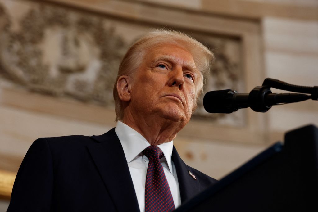 Donald Trump has told businesses they should make their products in the US, or face paying tariffs, while speaking at Davos.