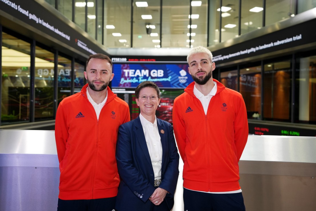 Team GB's Ben Lane (left) and Sean Vendy (right) with CEO of London Stock Exchange Julia Hoggett during the Team GB Paris 2024 Badminton team announcement at The London Stock Exchange, London