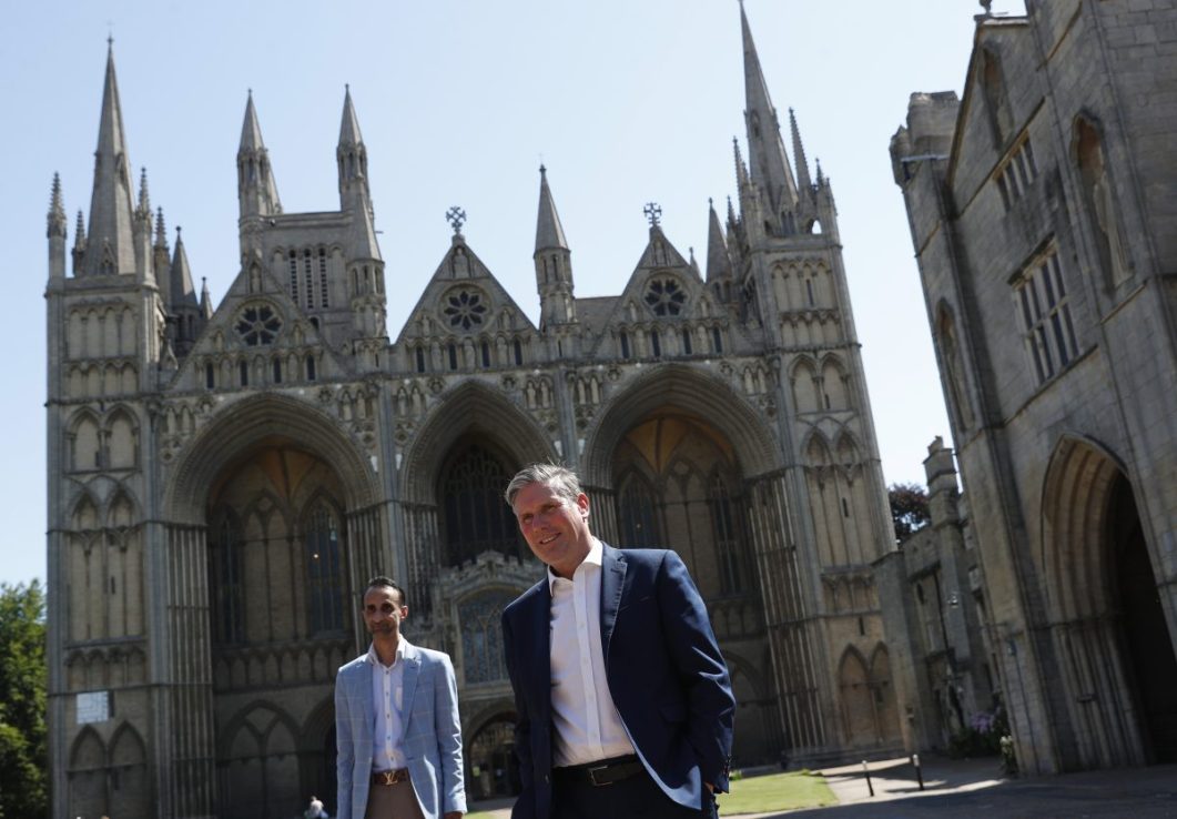 PETERBOROUGH, ENGLAND - JULY 31: Labour leader Keir Starmer walks with Councillor Shaz Nawaz in the Cathedral grounds during the launch of the 'Jobs Jobs Jobs' campaign on July 31, 2020 in Peterborough, England. The Labour Party has warned the government it has 24 hours to change course on its disastrous one-size-fits-all plans to withdraw furlough – or risk a “historic mistake” that would hand P45 notices to workers across the country. (Photo by Darren Staples/Getty Images)