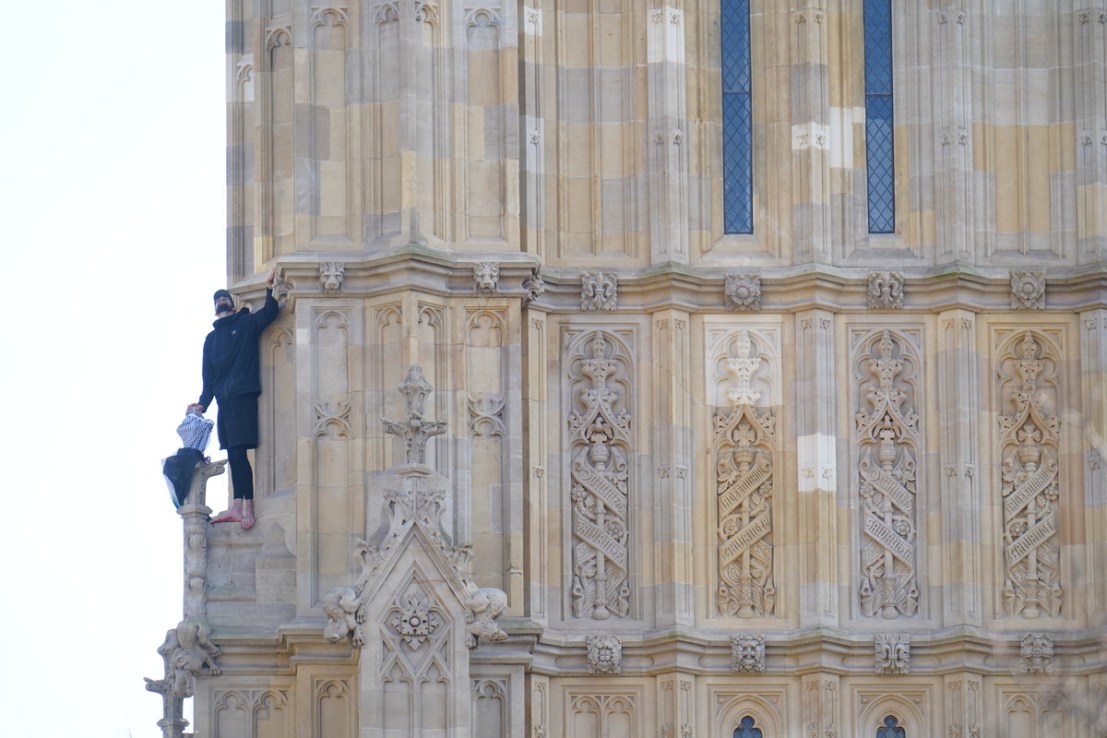 People watch a man with a Palestine flag after he climbed up Elizabeth Tower, which houses Big Ben at the Palace of Westminster in London. Picture date: Saturday March 8, 2025. James Manning/PA Wire
Copyright notice:
© 2025 PA Media, All Rights Reserved