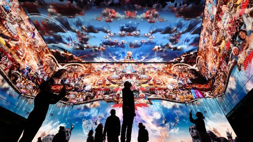 LONDON, ENGLAND - JANUARY 20: People pose for photographs during a photocall for Marco Brambilla’s new work "Heaven’s Gate" on the 16K screens of the Outernet London display on January 20, 2023 in London, England. Soho's new media and culture location, Outernet London, is one of the most advanced in the world using the latest immersive technology and is part of the ongoing regeneration of Soho. The multi-screen facility covers an area of 23,000 square feet, and allows for 360 degree presentations and displays across four storeys. (Photo by Leon Neal/Getty Images)