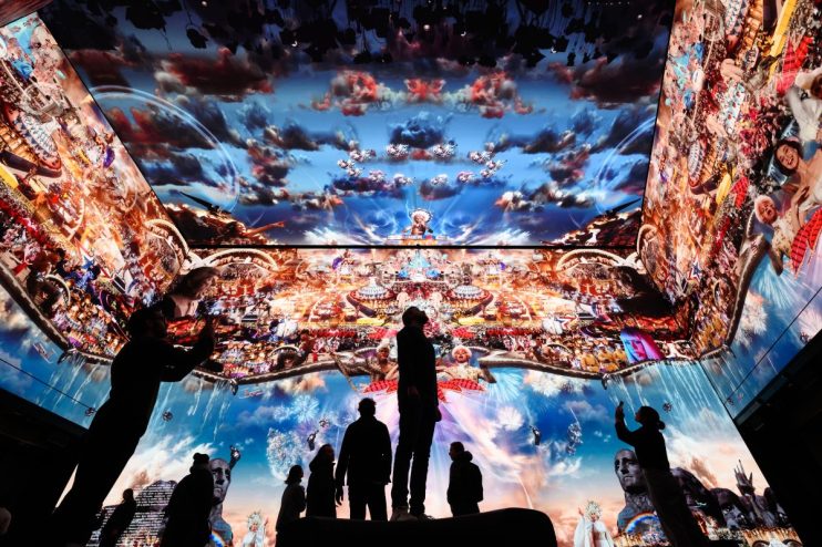 LONDON, ENGLAND - JANUARY 20: People pose for photographs during a photocall for Marco Brambilla’s new work "Heaven’s Gate" on the 16K screens of the Outernet London display on January 20, 2023 in London, England. Soho's new media and culture location, Outernet London, is one of the most advanced in the world using the latest immersive technology and is part of the ongoing regeneration of Soho. The multi-screen facility covers an area of 23,000 square feet, and allows for 360 degree presentations and displays across four storeys. (Photo by Leon Neal/Getty Images)