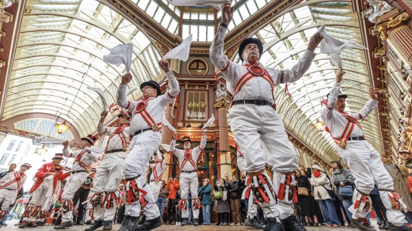 LONDON, ENGLAND - APRIL 23: The Ewell St Mary's Morris Men dance at Leadenhall Market on April 23, 2025 in London, England. City workers and tourists watch the Ewell St Mary's Morris Men performing in traditional costume complete with bells and handkerchiefs ahead of St George's Day, which falls next Monday instead of the usual April 23rd, due to the Easter period. (Photo by Dan Kitwood/Getty Images)