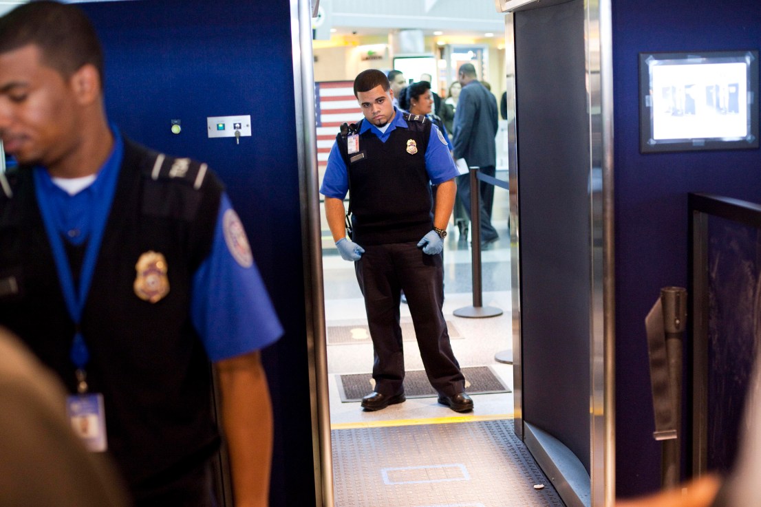 NEW YORK - OCTOBER 22:  A TSA officer stands next to the first Advanced Imaging Technology unit during a demonstration at John F. Kennedy International Airport's Terminal 8 passenger security checkpoint on October 22, 2010 in the Queens borough of New York City.  The new backscatter X-ray full-body scanners, which are optional, can see through clothing and will screen passengers for metallic and non-metallic threats including explosives.  (Photo by Michael Nagle/Getty Images)
