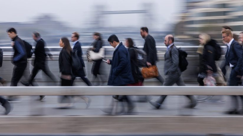 LONDON, ENGLAND - OCTOBER 15: Commuters cross London Bridge on October 15, 2024 in London, England. Estimates for the September 2024 payroll indicate that the number of employees rose by 0.4% compared with September 2023, a rise of 113,000 employees. (Photo by Dan Kitwood/Getty Images)
