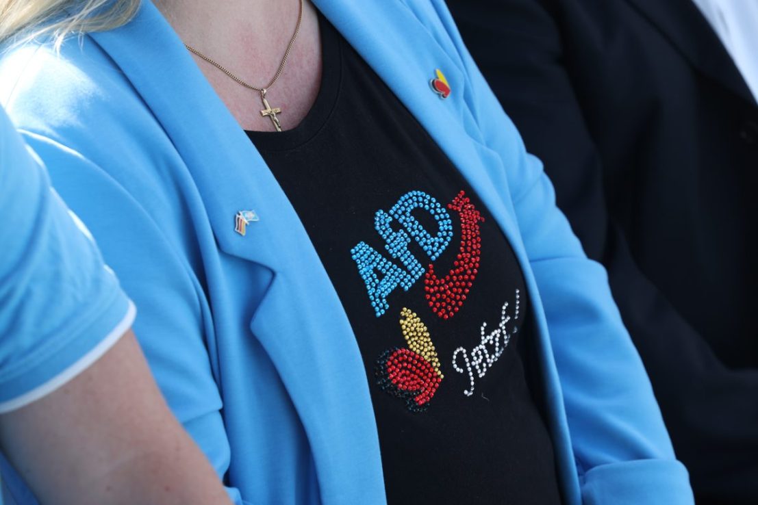TEMPLIN, GERMANY - MAY 01: People, including a woman wearing an AfD-themed shirt, attend a May Day fest of the far-right Alternative for Germany (AfD) on May 01, 2025 in Templin, Germany. Voters in Templin will vote on Sunday to elect a new mayor in a runoff between an AfD and a German Social Democrats (SPD) candidate. The AfD is currently in first place in nationwide polls, slightly ahead of Germany's Christian Democrats (CDU/CSU). An AfD win on Sunday would be the party's first mayoral win in the state of Brandenburg. Templin is the home of former German Chancellor Angela Merkel.  (Photo by Sean Gallup/Getty Images)