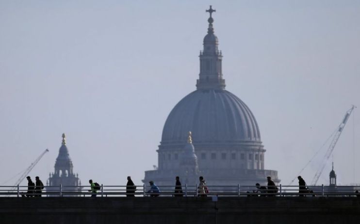 UK employment - workers walk on a bridge near St Paul's